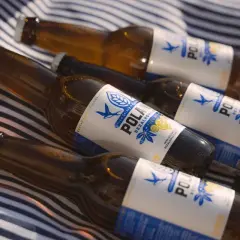 Butelki piwa bezalkoholowego na kocyku. Szukasz piwa, które ma najmniej węglowodanów? Te butelki mogą być odpowiedzią.