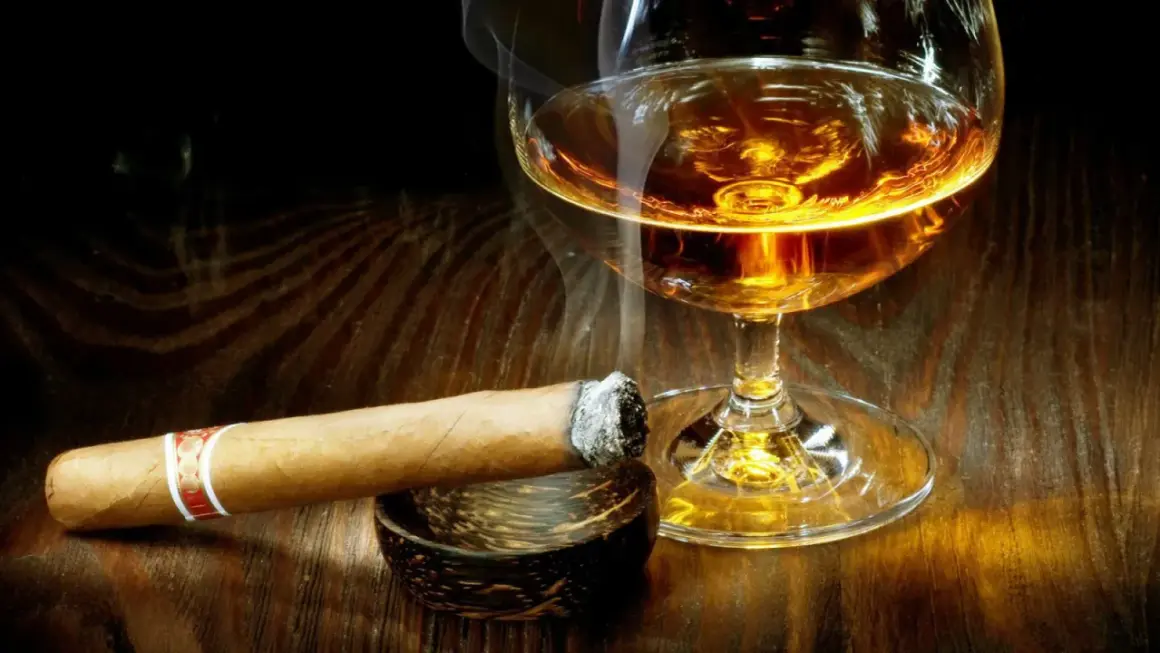 Dymiące cygaro i kieliszek bursztynowego trunku. Czy whisky podnosi cukier? To pytanie zadaje sobie wielu, delektując się tym zestawieniem.